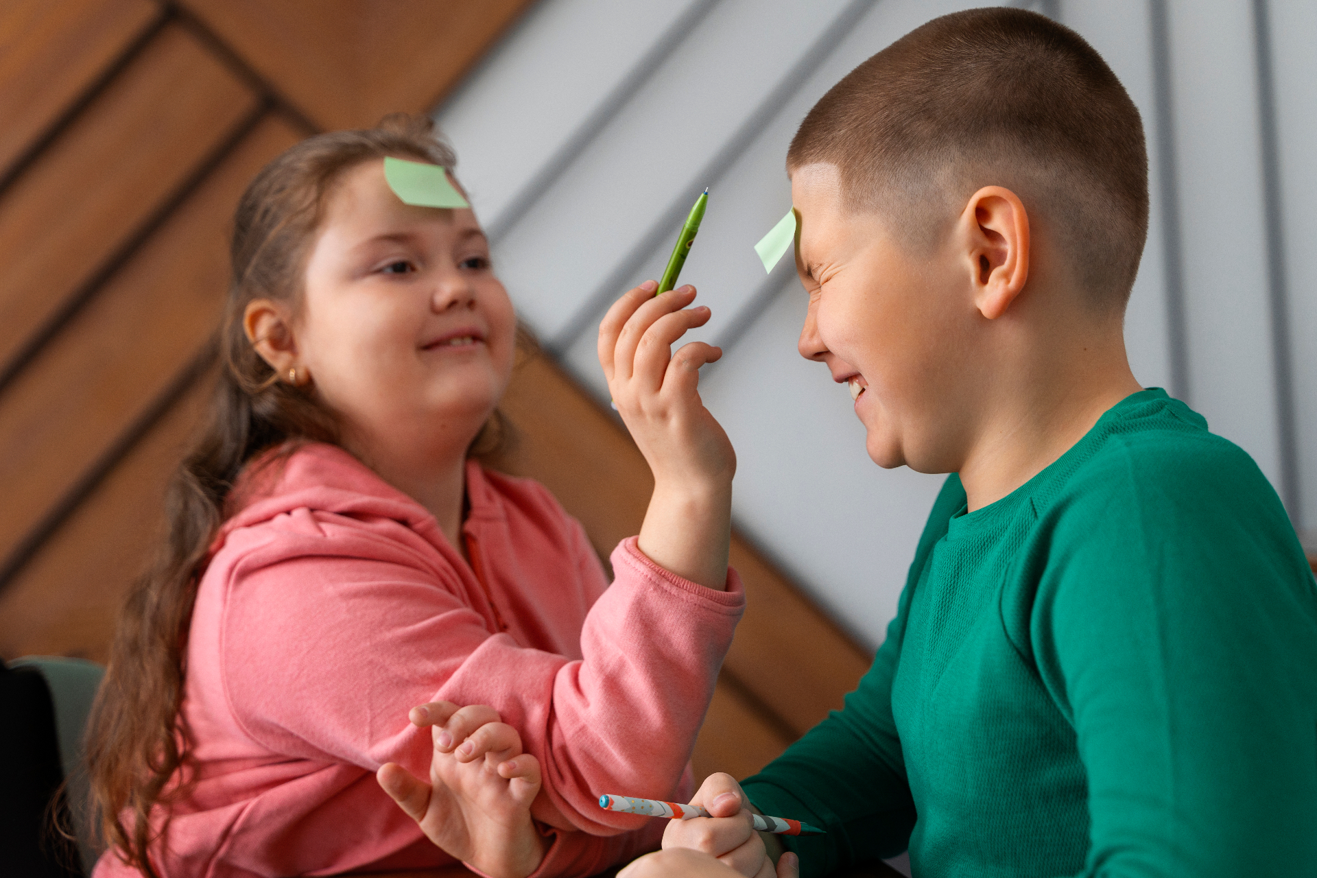 Two children laughing and playing together at school